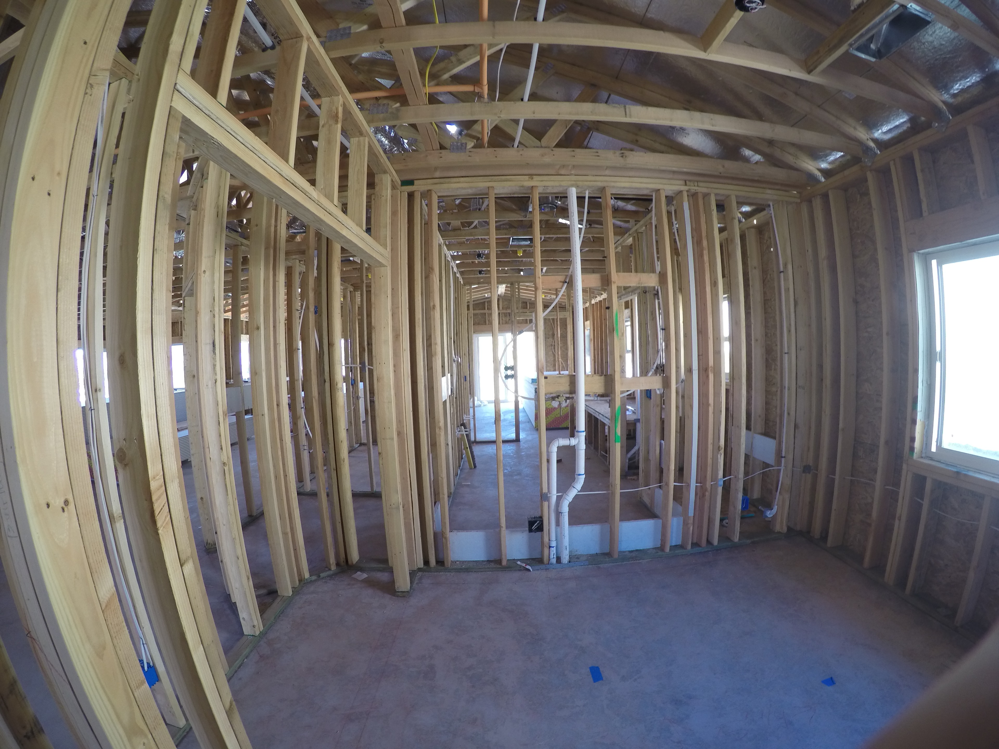 Interior residential framing with curved roof trusses by Capps Construction