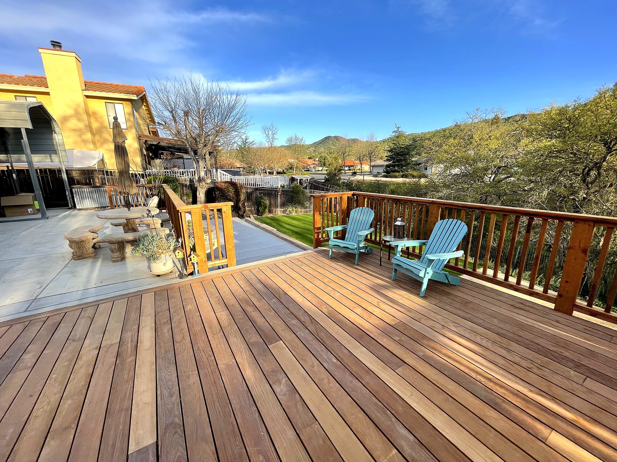 Hardwood deck with wood railing overlooking the hills by Capps Construction