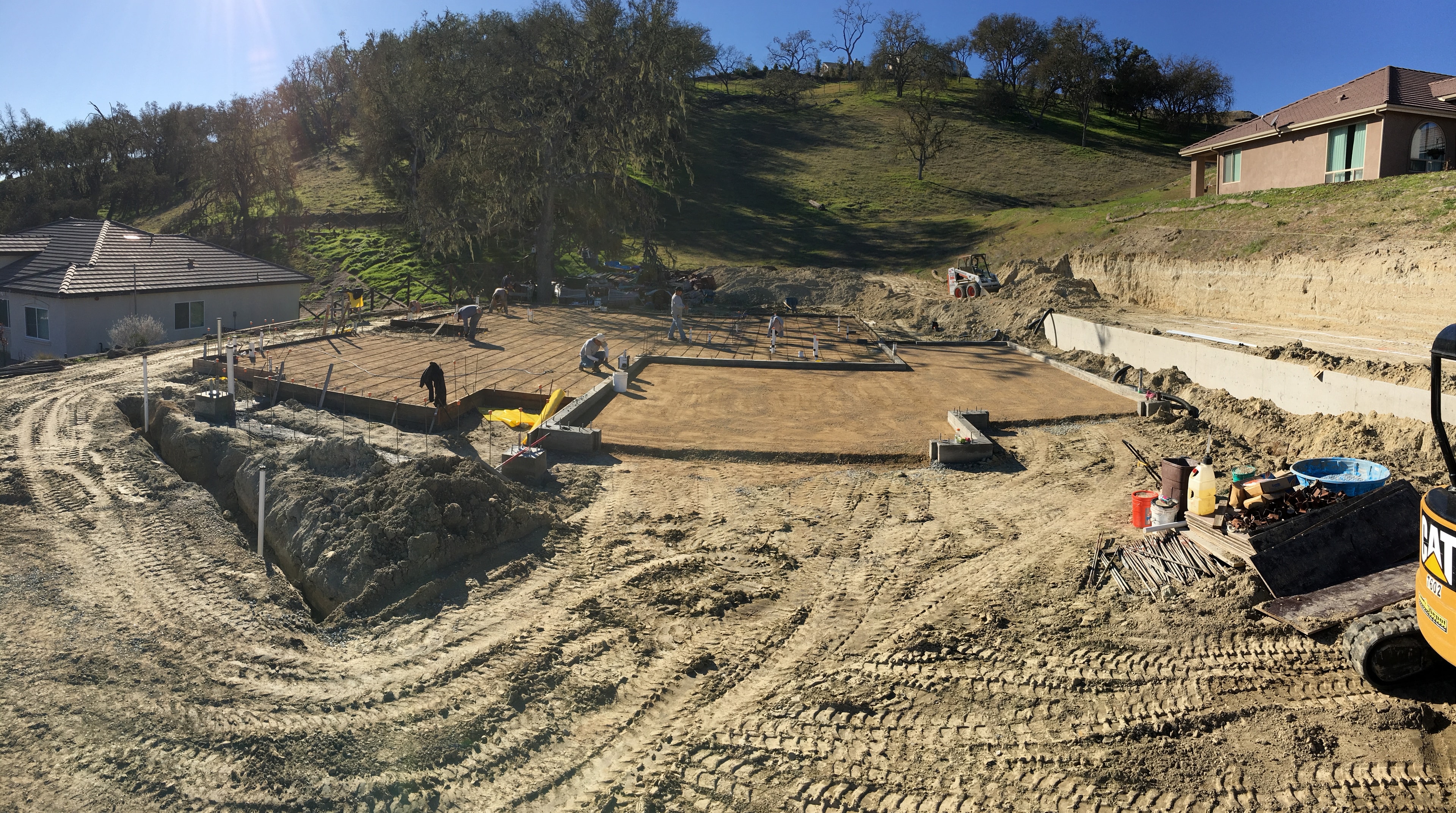 Concrete footings and compacted pad prepared for a new home foundation